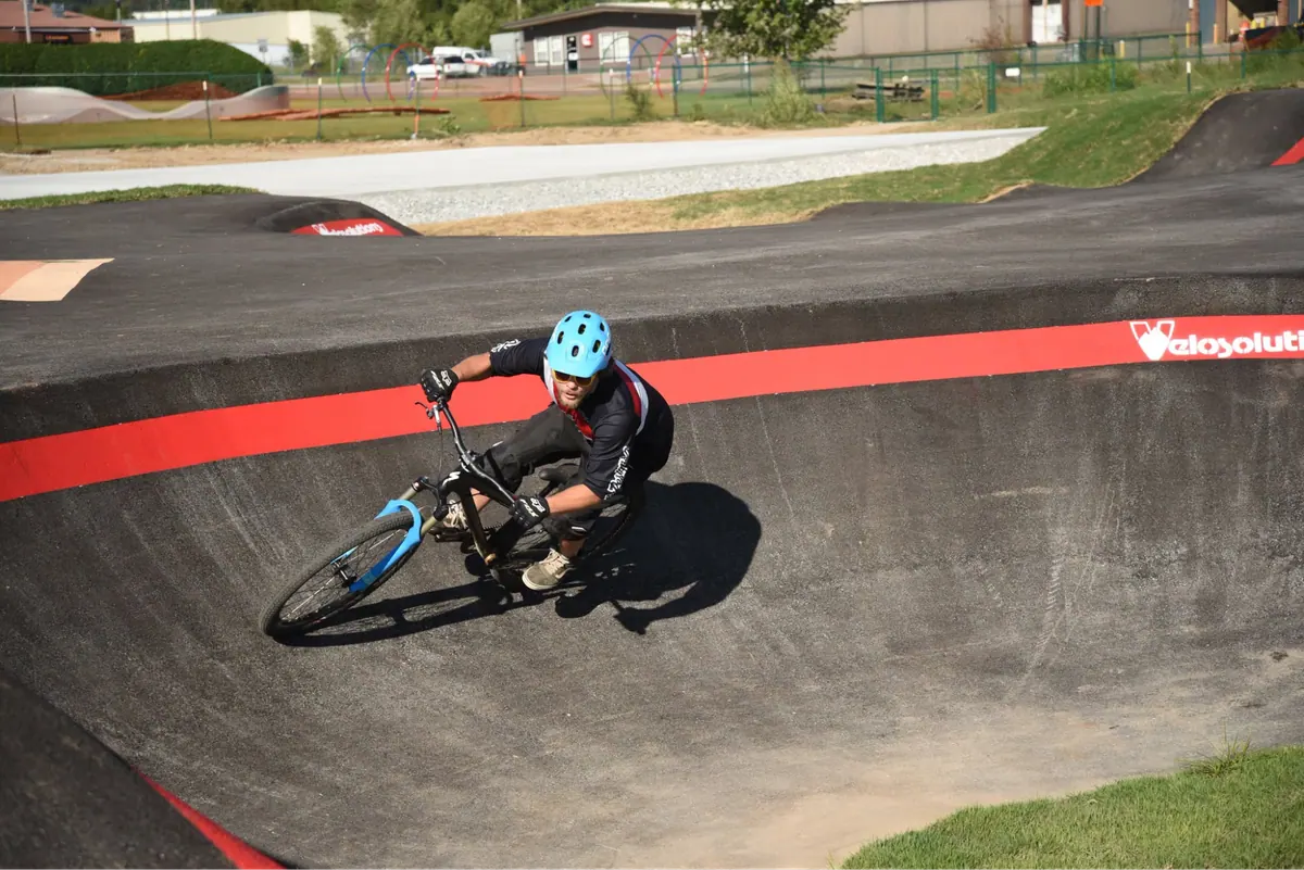 Rider leaning into a banked turn on the pump track