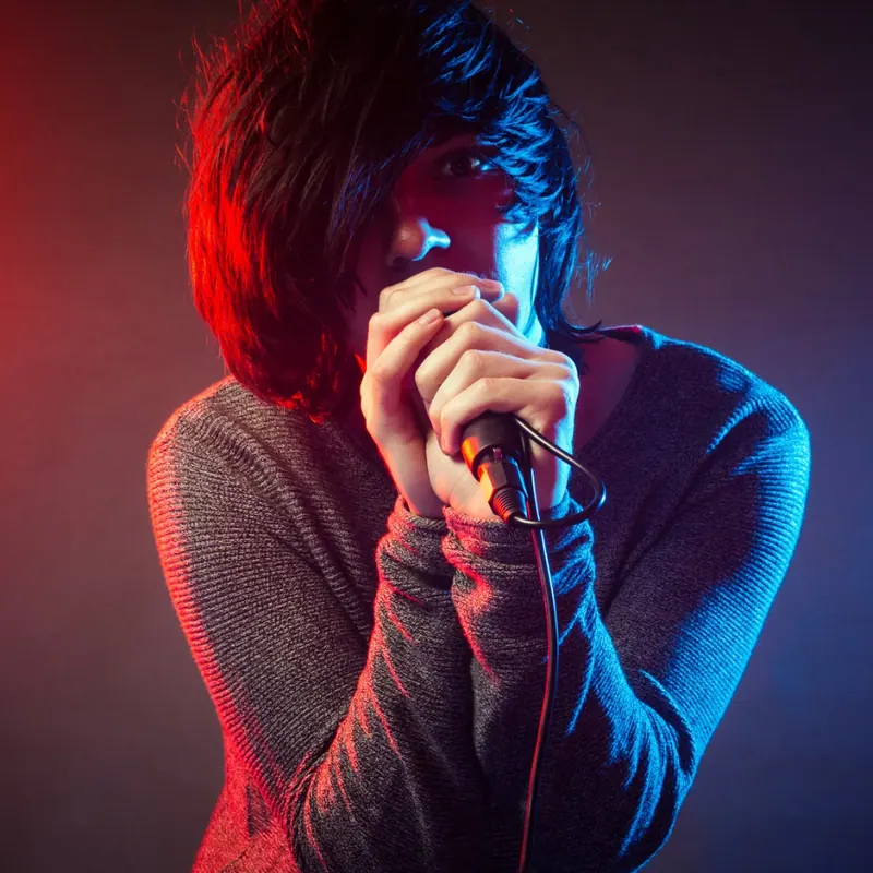 an emo guy singing in the image